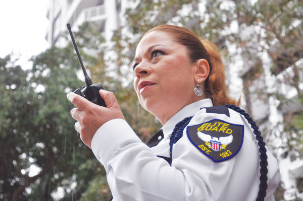 A lady with a radio working for Elite Guard's Security Company