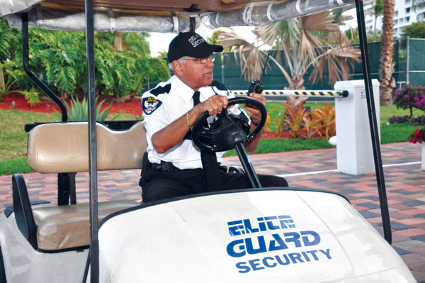 A man driving a Elite Guard Security Golf Cart. Part of Elite Guards Security Guard Services